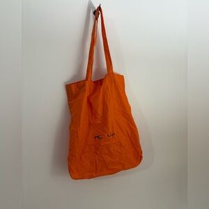 Kjus reusable nylon shopping bag in orange with logos